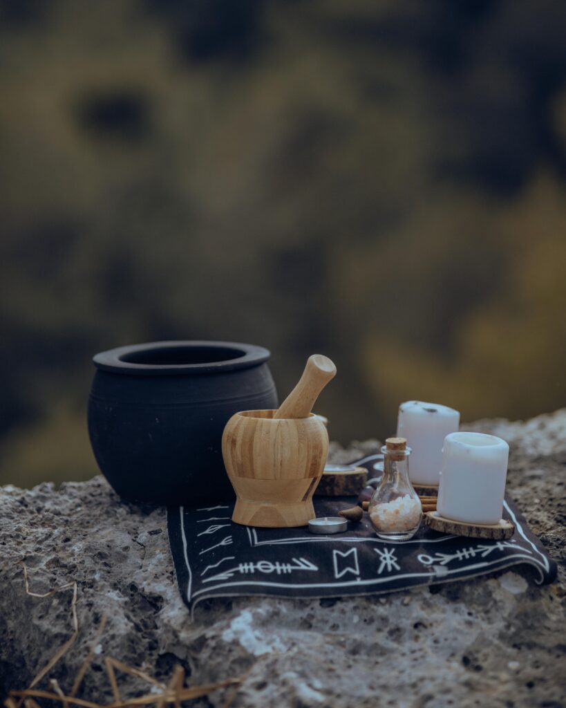 A Pot, a Mortar and Candles on a Rocky Surface